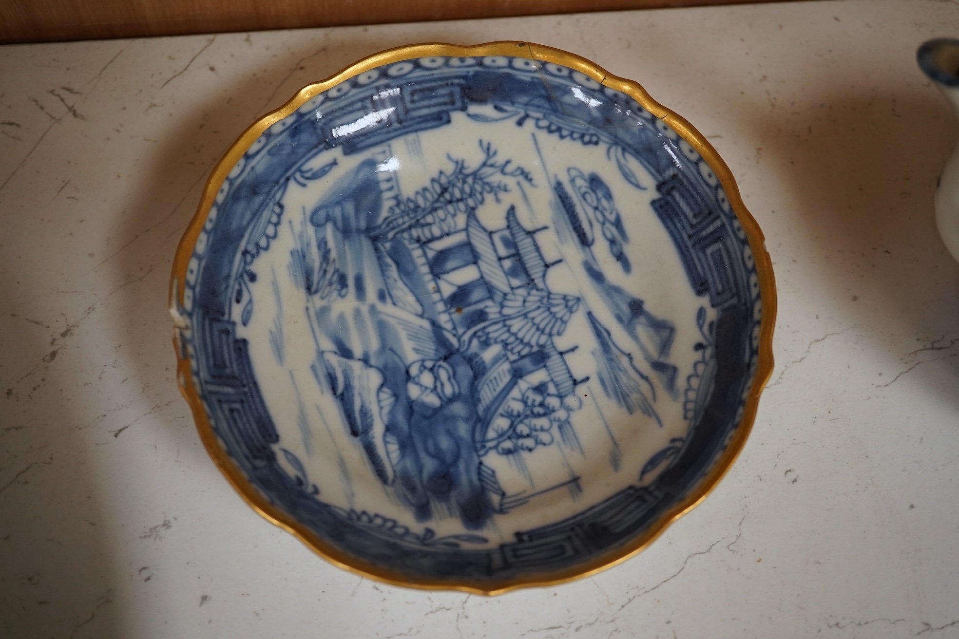 A Worcester teapot, c.1770, an 18th century Chinese famille rose and a blue and white dish, a small blue and white dish, a cup and saucer and teapot, largest dish 39cm (7). Condition - most damaged, cracked or chipped